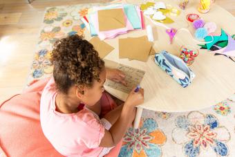 Young girl making a card