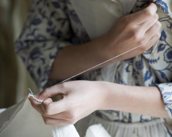 colonial girl sewing