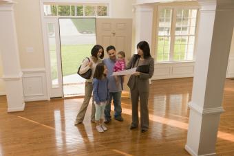 Family examining floor plan