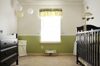 A bee themed neutral nursery room with shades