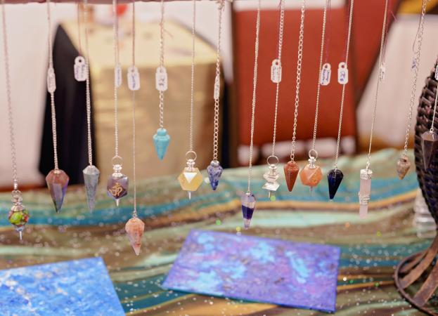 gemstone pendulums hanging on display