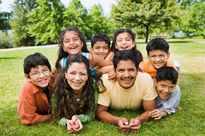 Family laying on grass pose