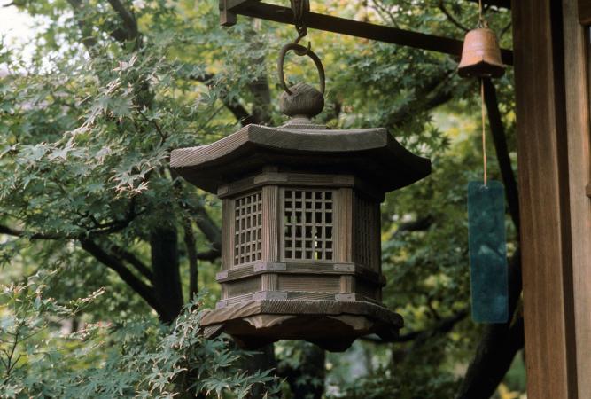 Lantern and wind chime hanging on porch