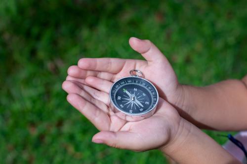 hands holding a compass