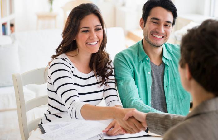 Couple shaking hands with Feng Shui adviser