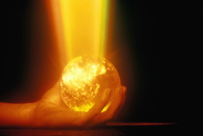Hand holding a glowing globe