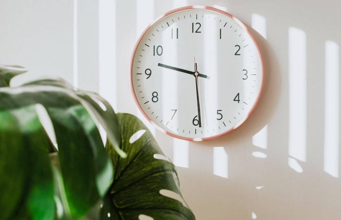 Pink clock hanging on a wall