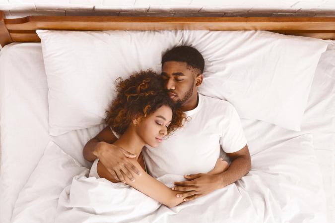 Couple sleeping together in bed