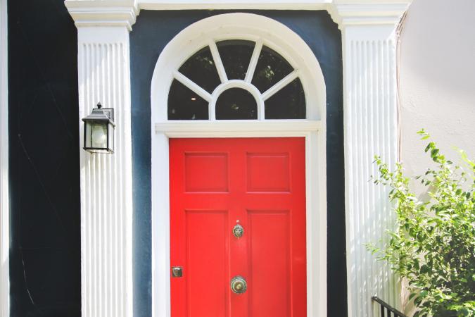 Front view of a red door in a row house