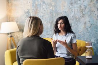 Woman psychologist talking to patient