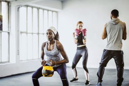 Small Group Of People Exercising in a Gym