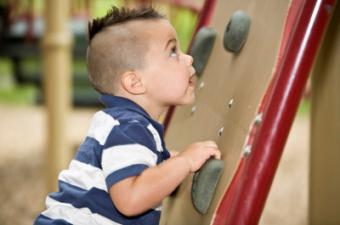 Boy climbing on wall