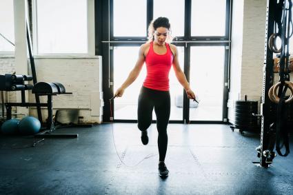 Young Woman Using Skipping Rope To Keep Fit