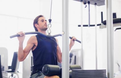 Man using exercise machine in gymnasium