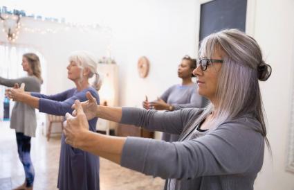 Serene women practicing tai chi in exercise class