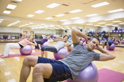 Group on fitness balls in exercise class