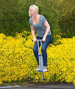 Woman using pogo stick for workout