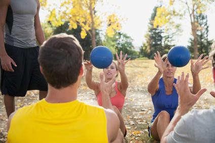 Tossing medicine ball to one another