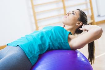 Woman exercising at home on a balance ball