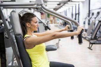 Young woman working out on exercise machine in a gym