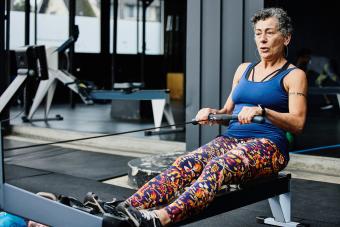 woman working out on rowing machine at outdoor gym