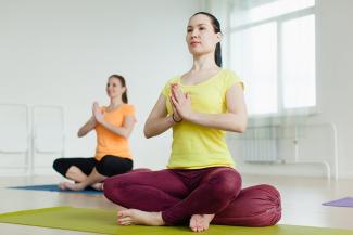 Women are practicing the Accomplished Pose