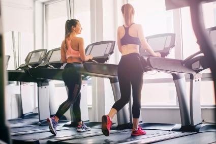 Girls exercising in the gym using a treadmill