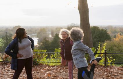 Active senior women friends stretching legs