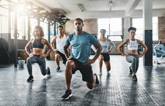 Group of young people doing lunges