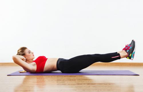 Fit girl doing physical exercises