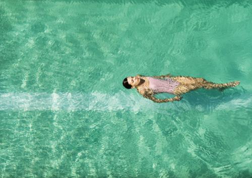 Overhead of woman floating in a pool