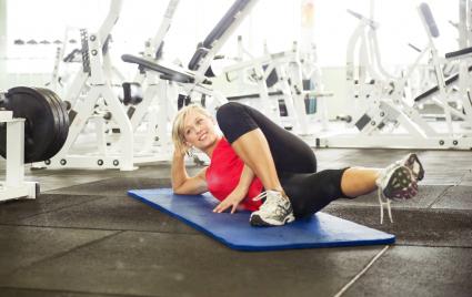 Woman stretching in gymnasium