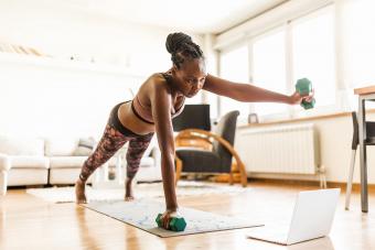 Woman home doing yoga sculpt class