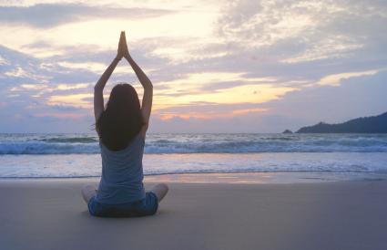 Woman Meditating At Beach