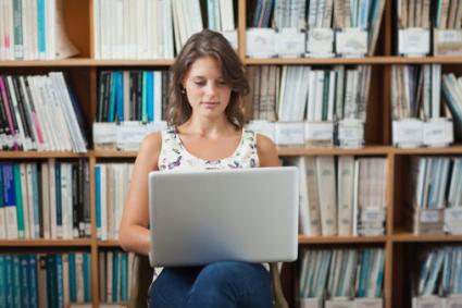 Woman using laptop in library