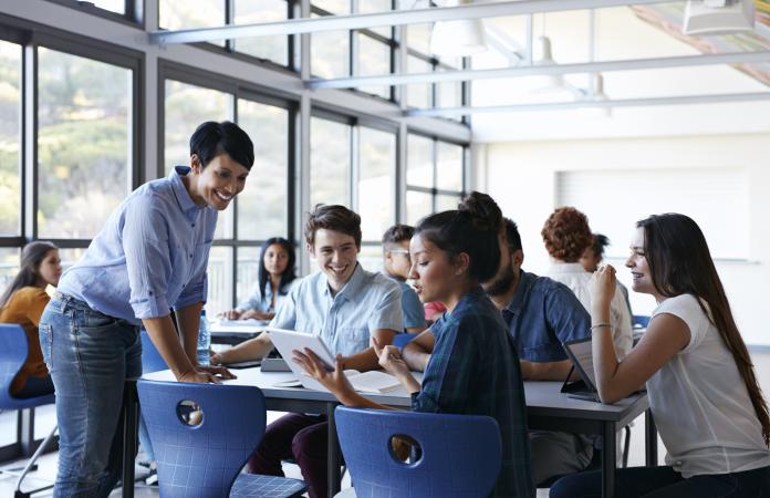 Teacher assisting students