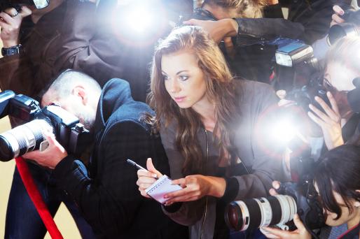 Young female journalist at news event