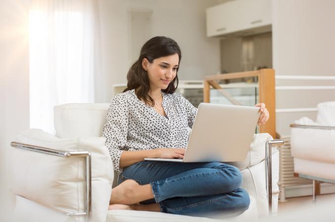 Woman writing on laptop