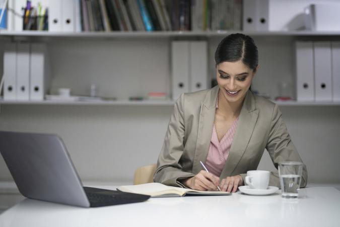 Woman writing at her desk