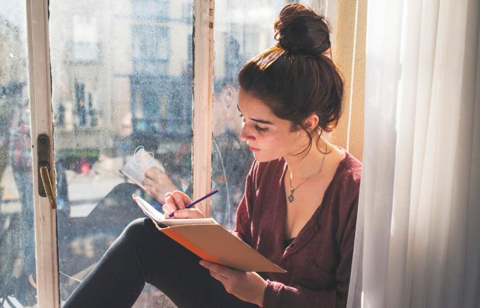 Young woman writing in a notebook