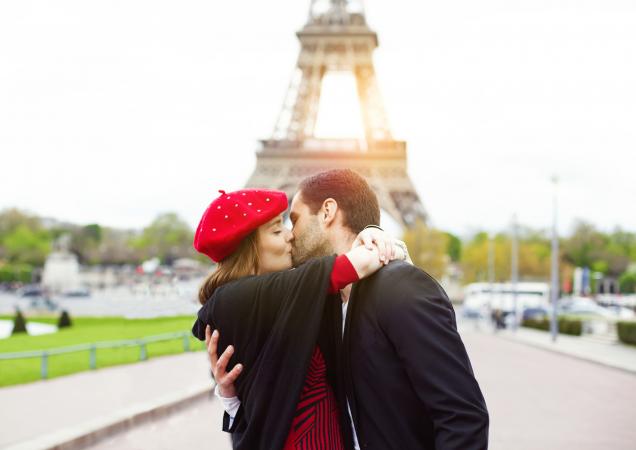 Romantic couple kissing near the Eiffel Tower in Paris
