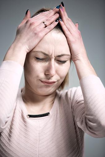 Sad woman holding her head