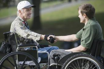 Mature war veteran shaking hands with a young man