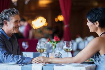 Mature couple holding hands at restaurant