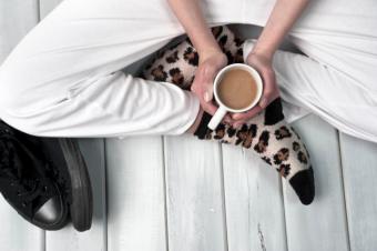 Woman on floor holding coffee mug