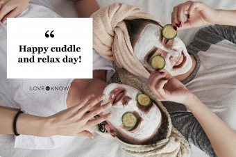Two women using white mask and cucumbers on the face