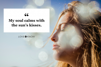 Serene woman basking in sunshine on beach
