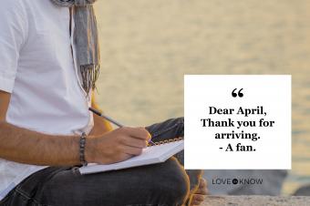 man writing in journal at beach