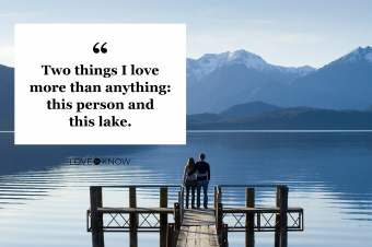 Young couple standing on lake pier