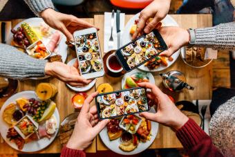 Friends taking pictures of food on the table